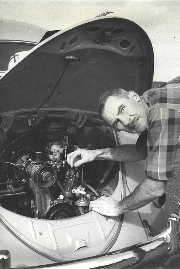 man fixing car