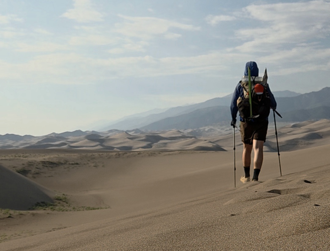 Donovan Rice hiking in a Colorado desert