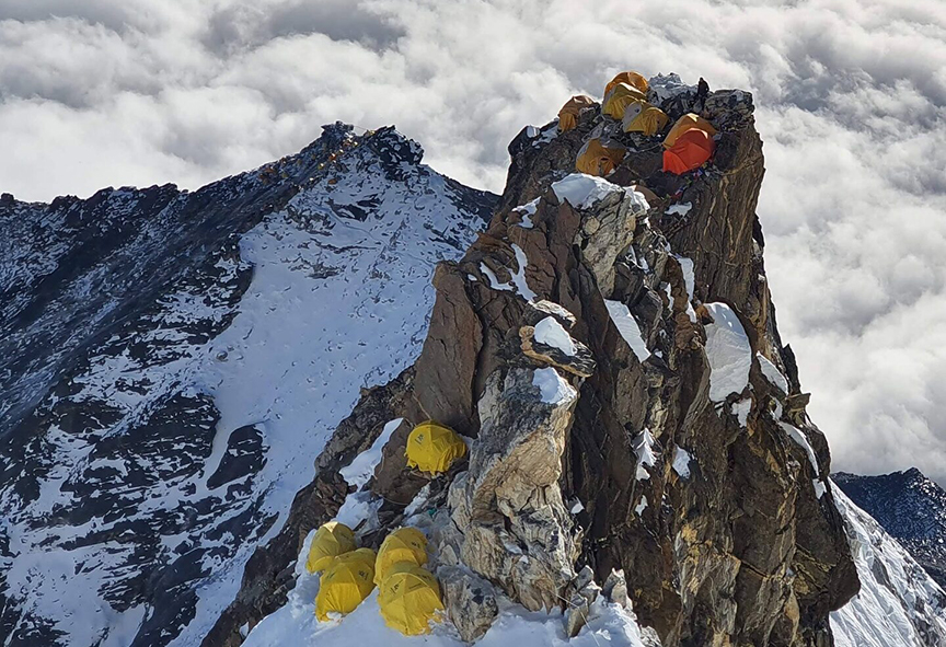 tightly packed tents on rocky spire