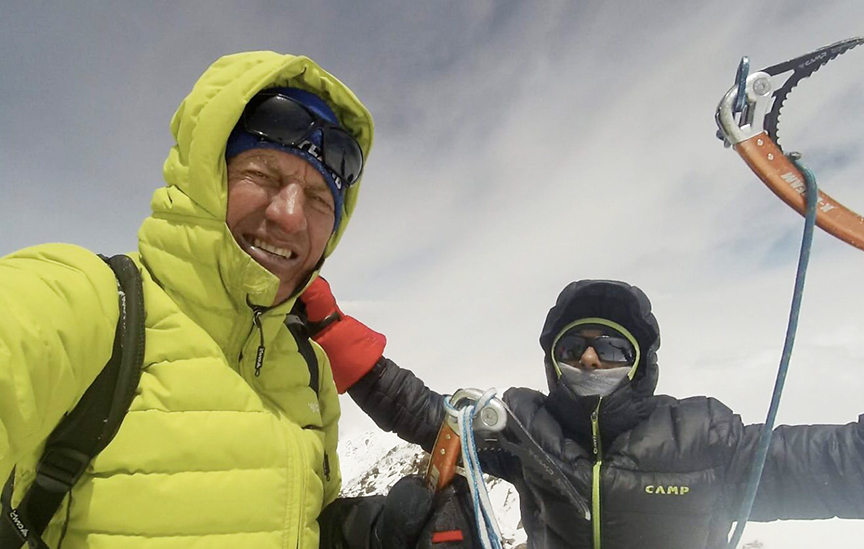 two mountaineers on a snowy summit