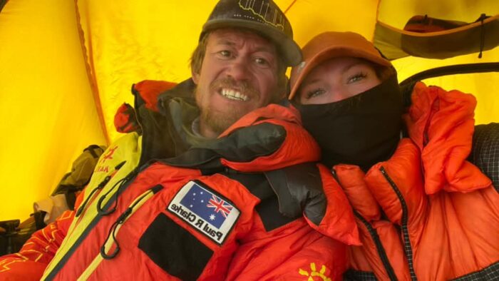 Two climbers inside a tent.