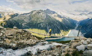 Mountain hiker crossing bridge