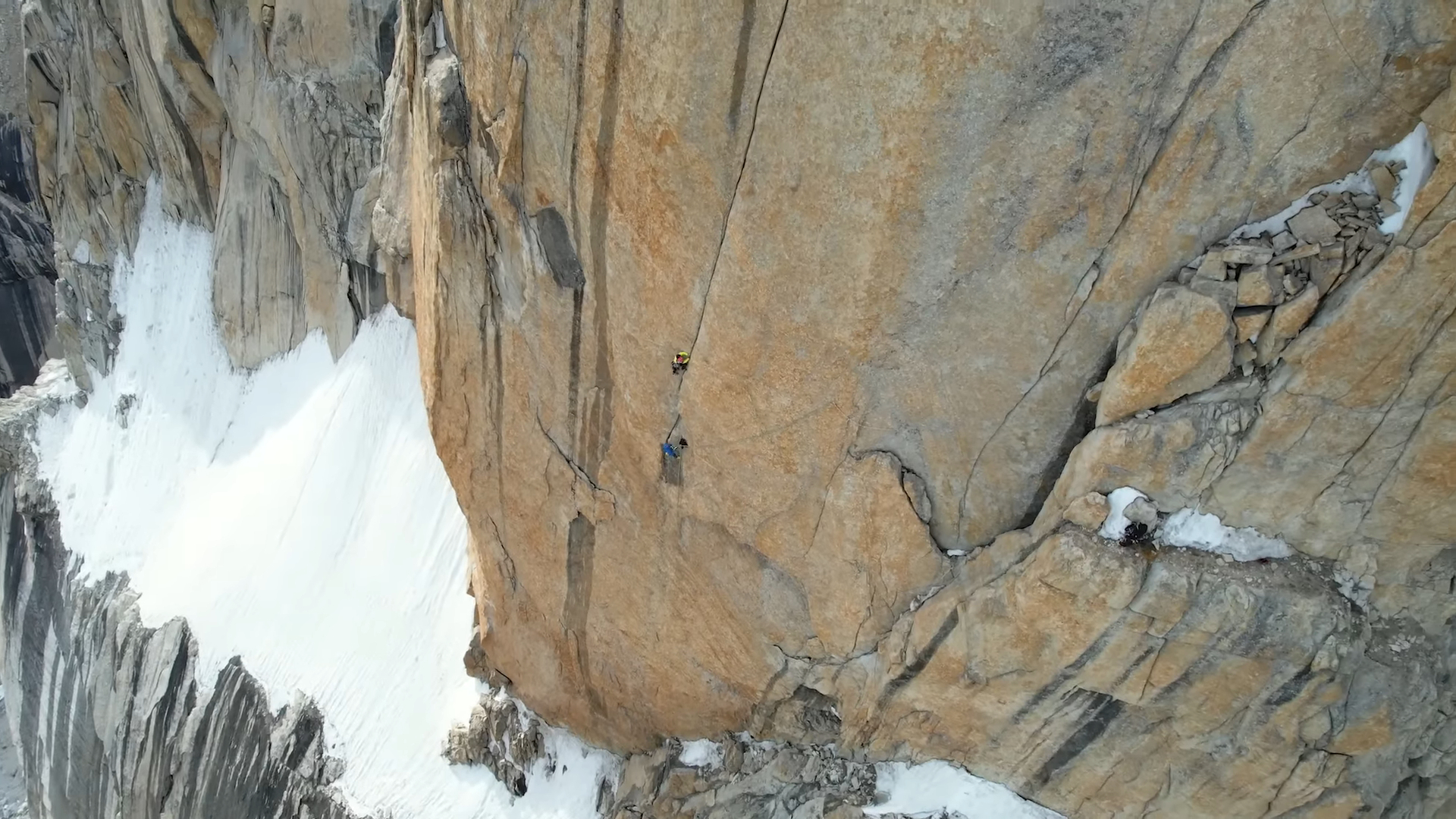 two climbers on a sheer rock wall
