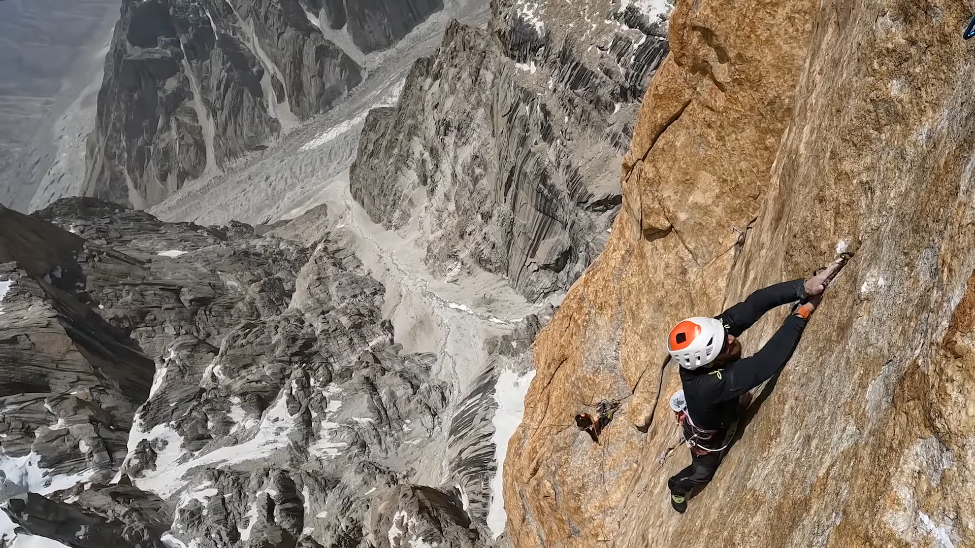 a man climbing a big rock wall