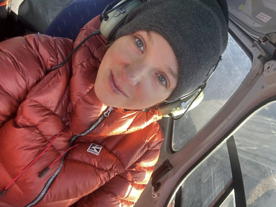 Close shot of a Russian female climber inside a helicopter. 