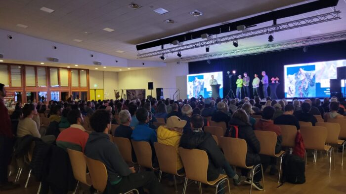 Public sitting in a hall.
