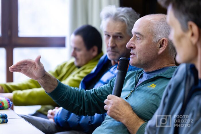 Climbers sitting at a table debating. 