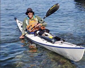 smiling man in kayak