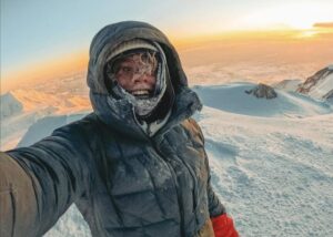 guy smiling atop Denali