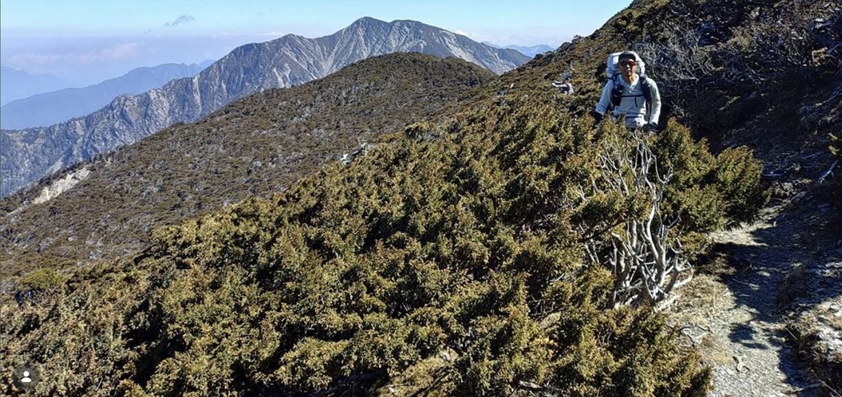 man hiking on open mountain slope