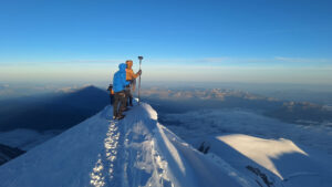 Surveyors with a GNSS pole on top of Mont Blanc.