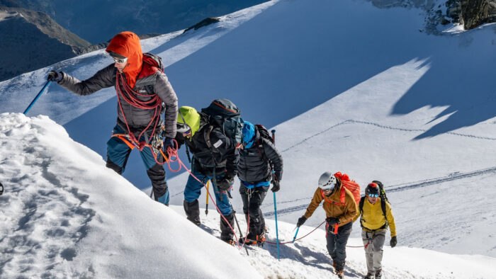 Climbers in line on a snowy slope. 